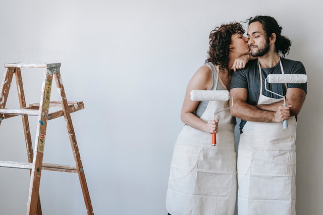 A couple painting their home