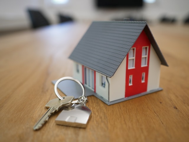A miniature house and a key.