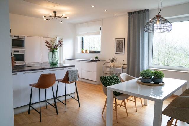 A kitchen that has a dining area integrated.