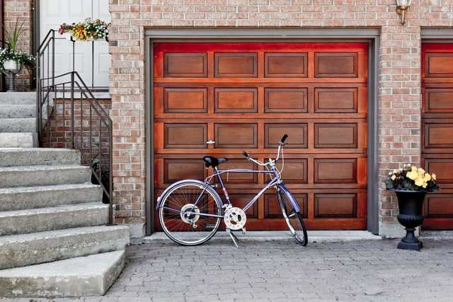A bicycle parked in front of a garage door