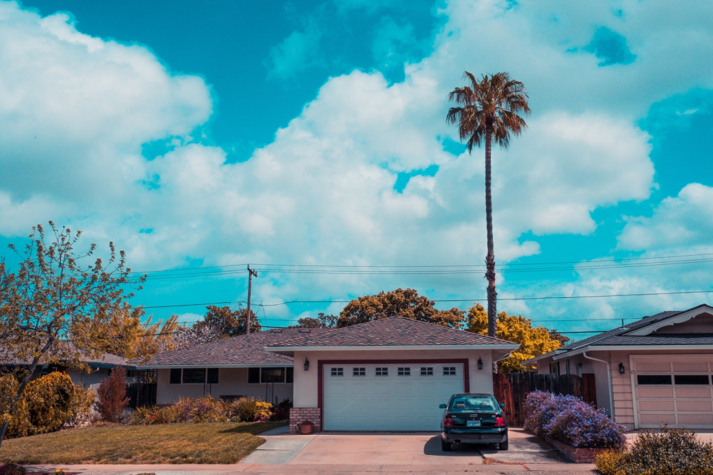 A house beneath a blue, cloudy sky