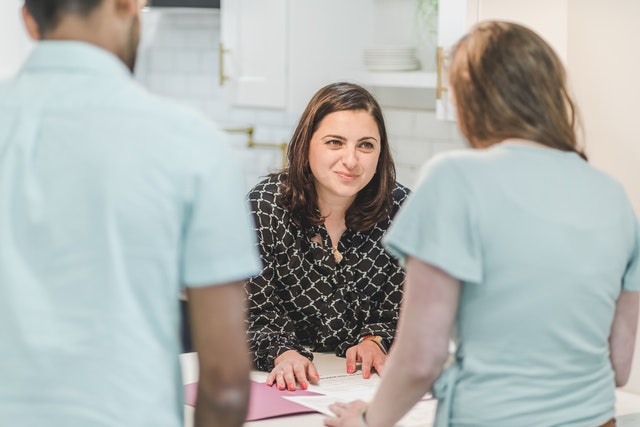 a couple selling a home talking to an agent