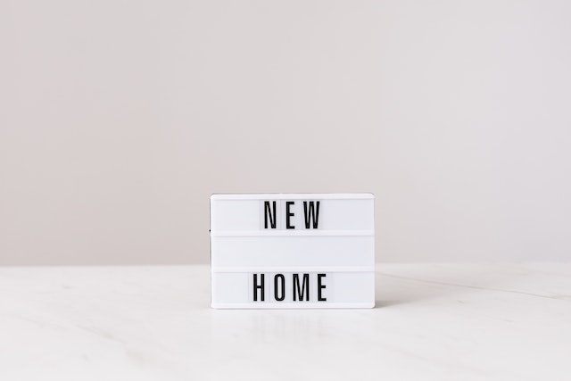 a new home sign on a white background