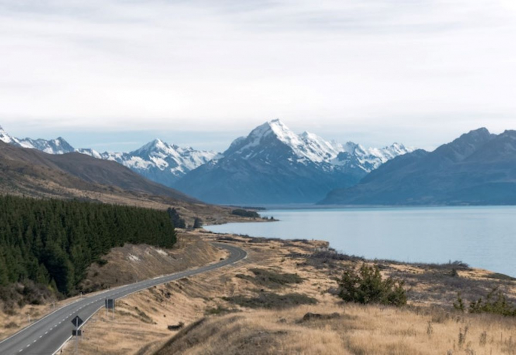 A view of the mountains, a water surface, and a road.