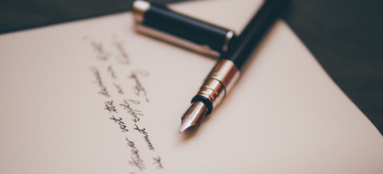 Pen and paper for writing an offer letter