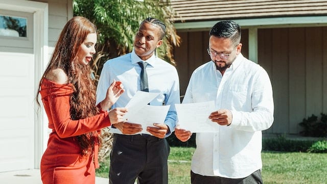 A man and woman talking to the real estate agent