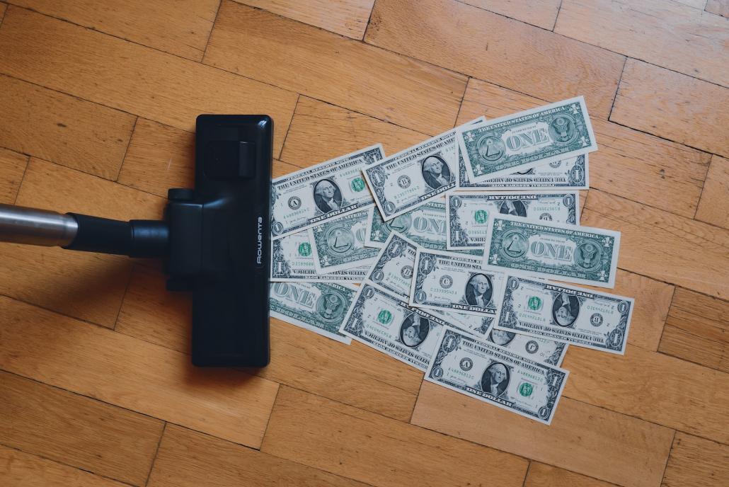 vacuum cleaner sucking in dollar bills