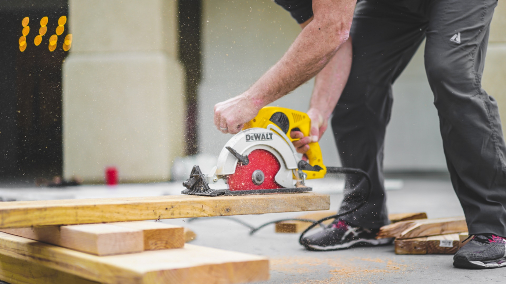 a person using a saw on boards when buying a new build home